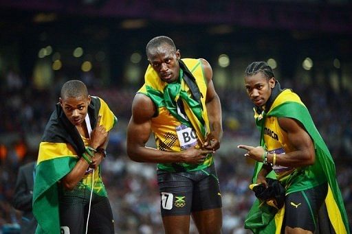 Jamaica's Usain Bolt (C) celebrates with Yohan Blake (R) and Warren Weir